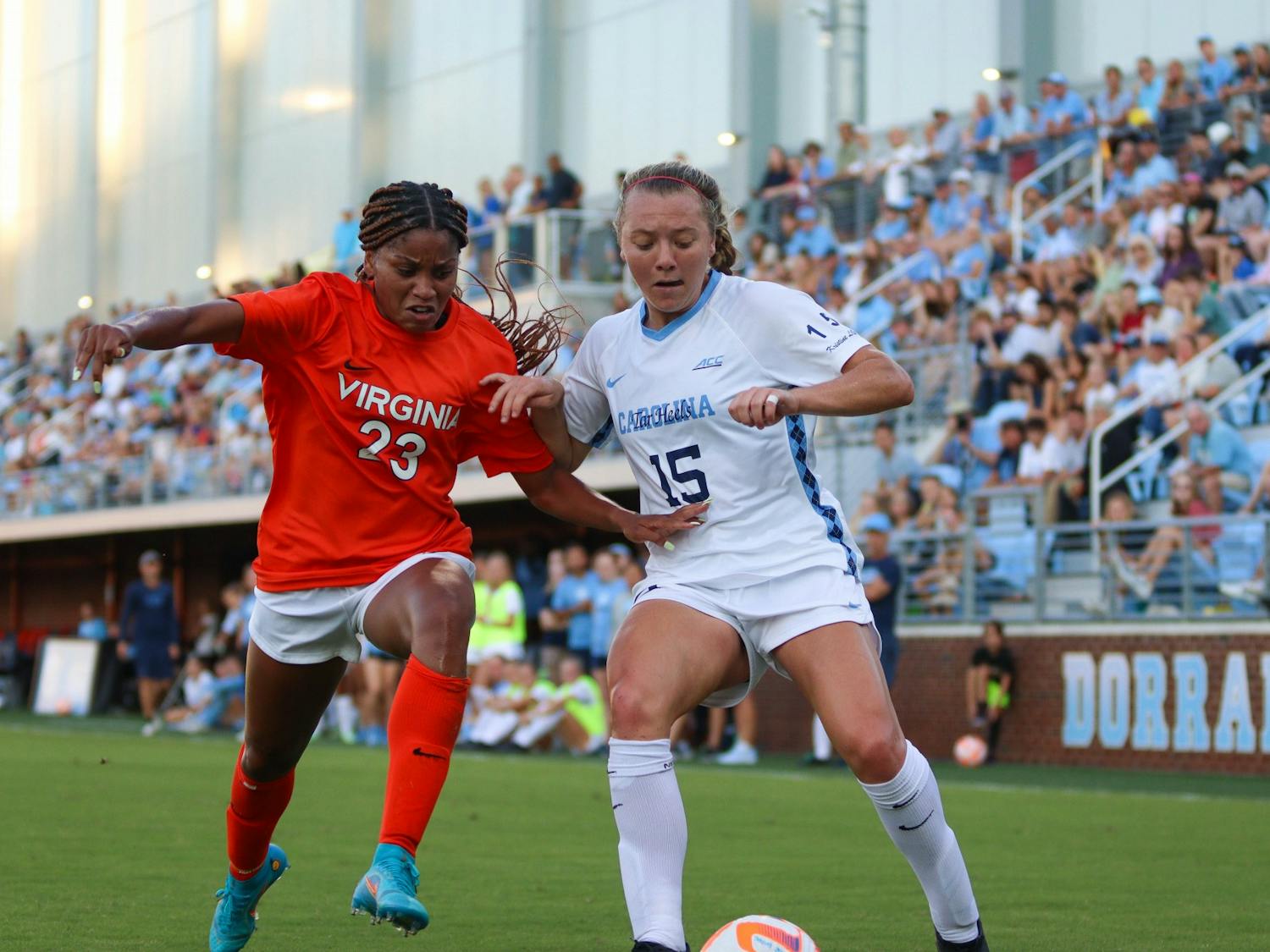 Sophomore forward Avery Patterson (15) fights for possession of the ball with UVA junior defender Laney Rouse (23). At halftime, UNC is leading 2-0 against UVA.