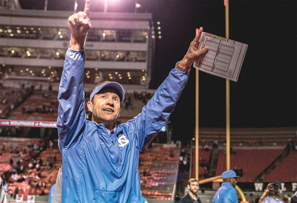 Coach Larry Fedora thanks fans at the end of both the Tar Heels' historic regular season and decisive 45-34 victory over N.C. State on Sunday.