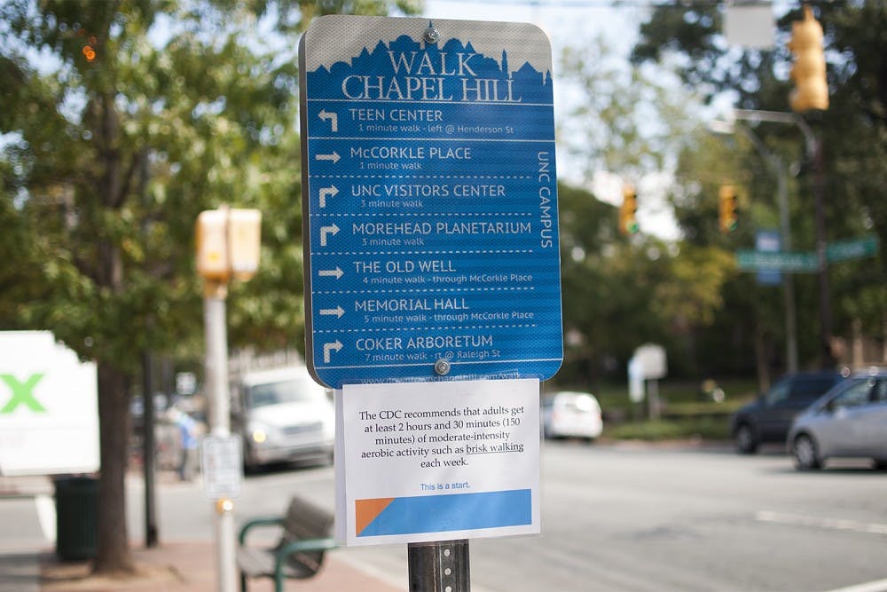 Walk Chapel Hill sign in front of the Courthouse gives directions to pedestrians to different downtown and campus destinations.