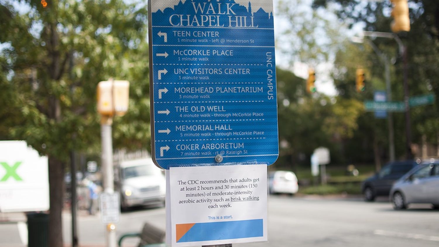 Walk Chapel Hill sign in front of the Courthouse gives directions to pedestrians to different downtown and campus destinations.