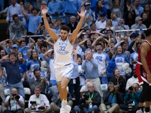 UNC graduate forward Pete Nance (32) celebrates a dunk in the Dean Smith Center on Jan. 21, 2023, against the N.C. State Wolfpack. UNC won 80-69.