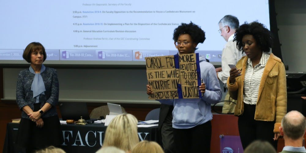 <p>Chancellor Carol Folt looks on as undergraduate students Angum Check and Tamia Sanders take the stage to show their disapproval of the proposal given by Folt about the re-erection of Silent Sam on UNC's campus.&nbsp;</p>