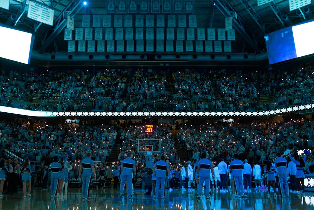 The UNC cheerleading team prepares to amp up fans at the Dean E. Smith Center before UNC basketball's home game against Michigan on Wednesday, Dec. 1, 2021. 