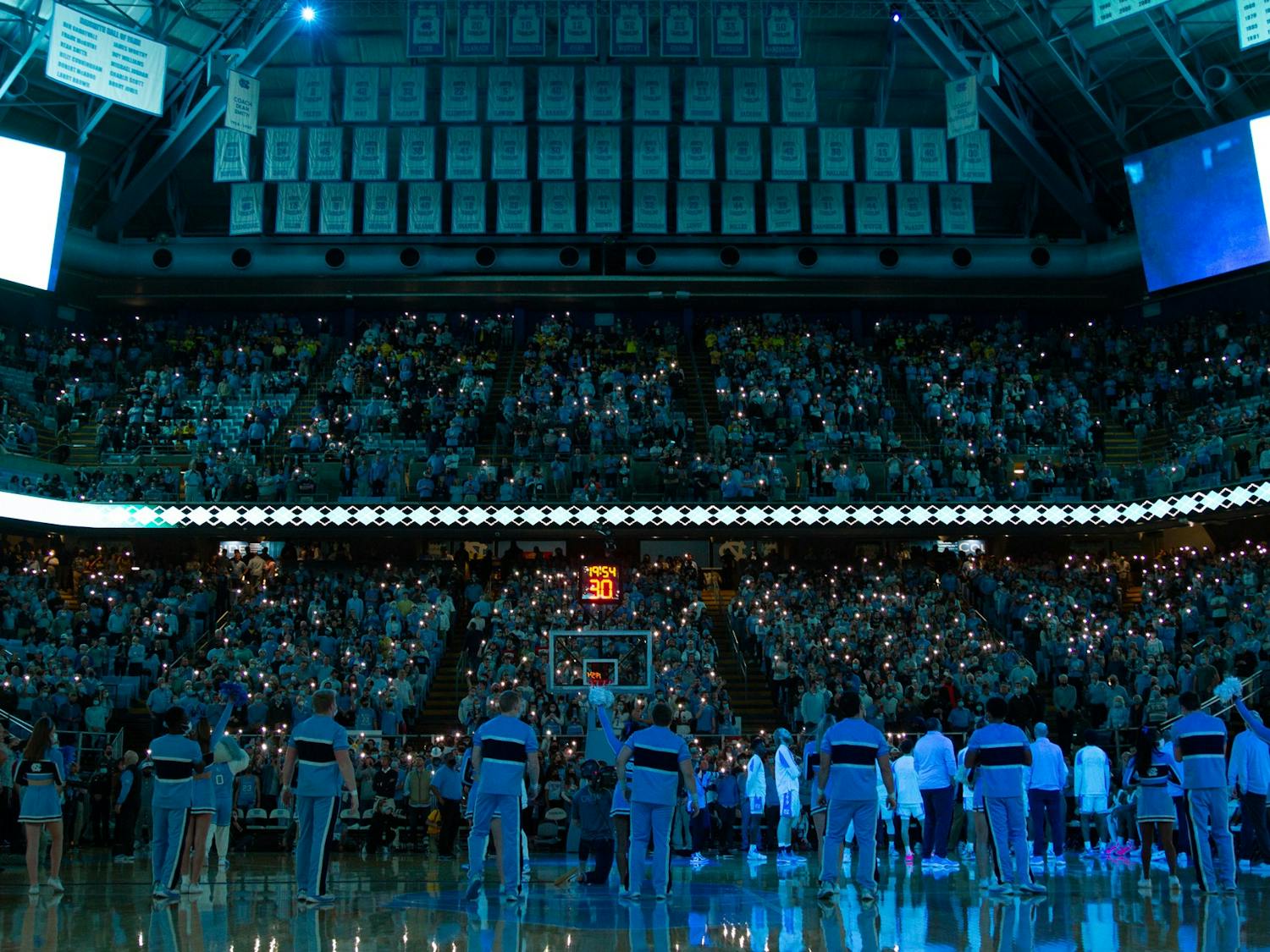 The UNC cheerleading team prepares to amp up fans at the Dean E. Smith Center before UNC basketball's home game against Michigan on Wednesday, Dec. 1, 2021. 