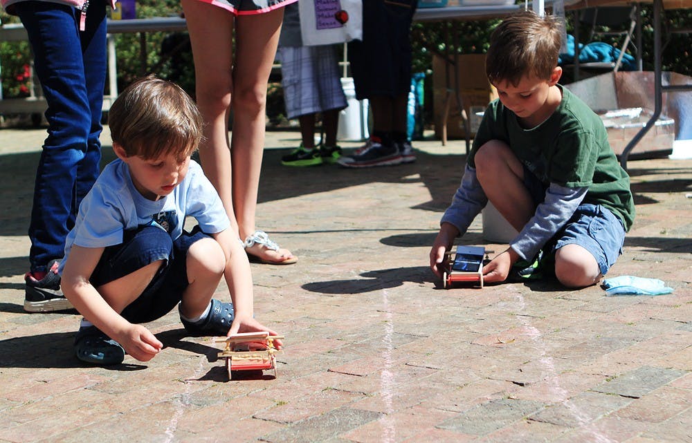 The North Carolina Science Festival took place at UNC on Saturday. The North Carolina Science Festival is an initiative of Morehead Planetarium and Science Center. Sam and Quinn Huckabee (ages 4 and 7) from Durham race solar powered cars. They came with their Dad. 