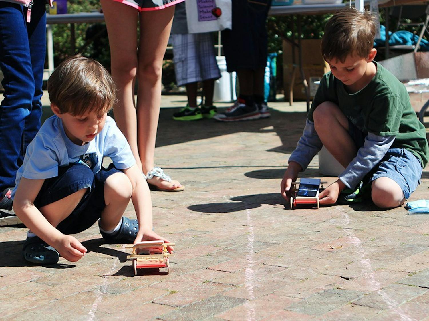 The North Carolina Science Festival took place at UNC on Saturday. The North Carolina Science Festival is an initiative of Morehead Planetarium and Science Center. Sam and Quinn Huckabee (ages 4 and 7) from Durham race solar powered cars. They came with their Dad. 