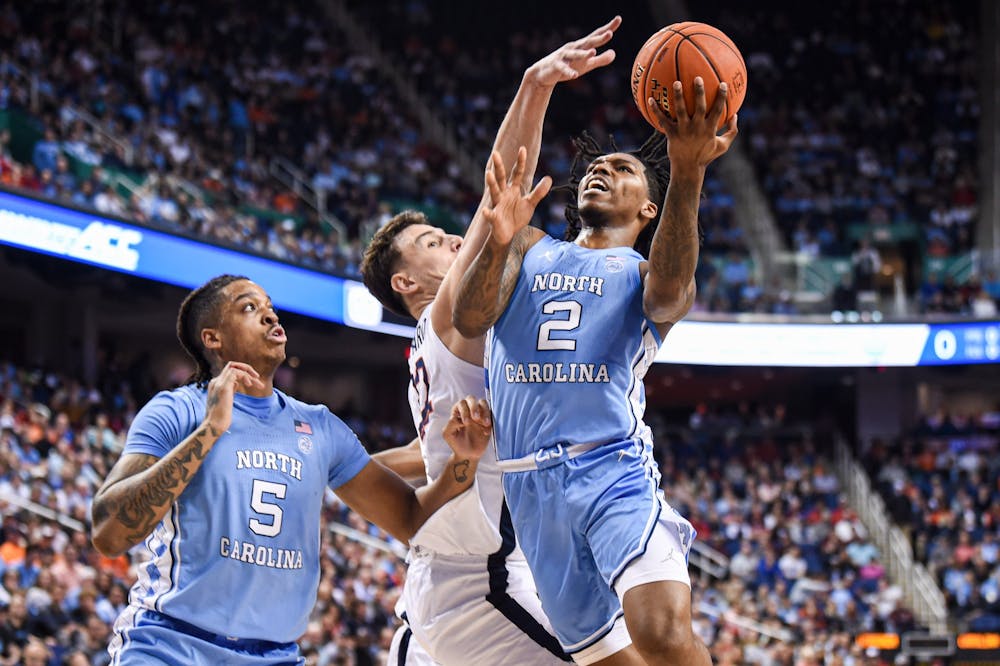 UNC junior guard Caleb Love (2) jumps toward the basket during the game against Virginia in the ACC Tournament Quarterfinals at Greensboro Coliseum on March 9, 2023.