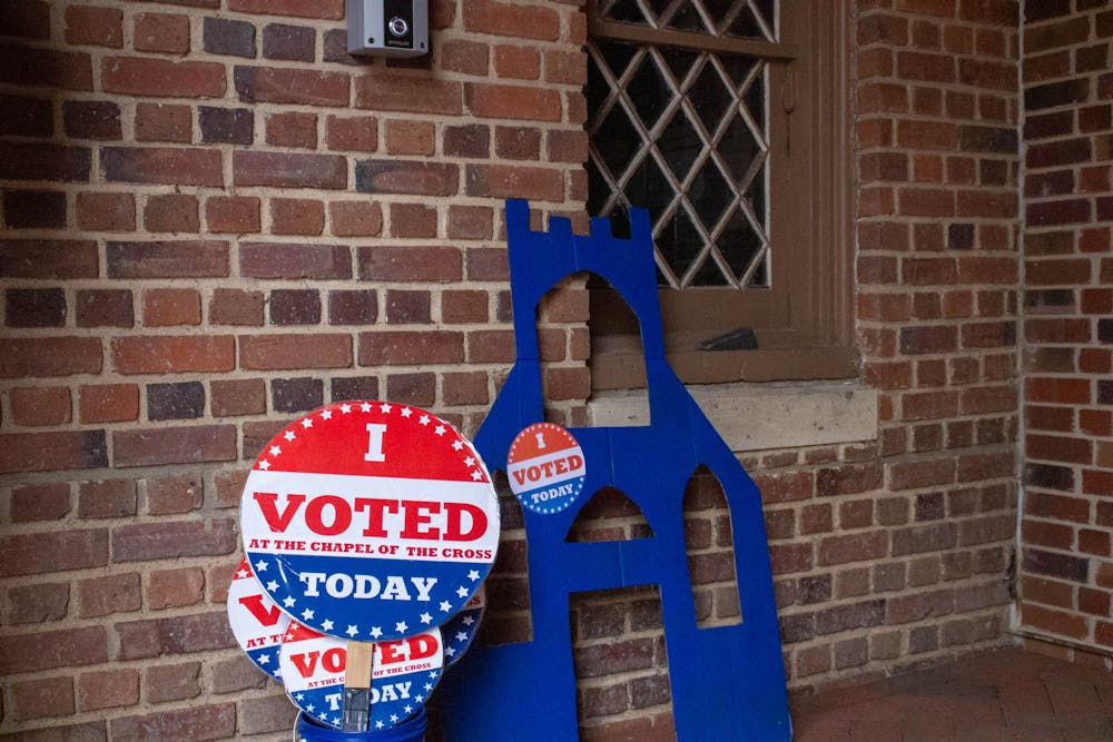Signs sit outside Chapel of the Cross in Chapel Hill, N.C., on Sunday, Oct. 30, 2022. Early voting is open to residents until Nov. 5.