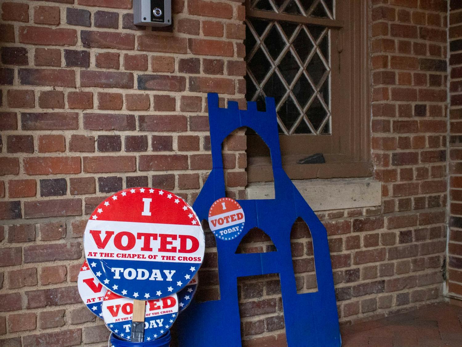 Signs sit outside Chapel of the Cross in Chapel Hill, N.C., on Sunday, Oct. 30, 2022. Early voting is open to residents until Nov. 5.