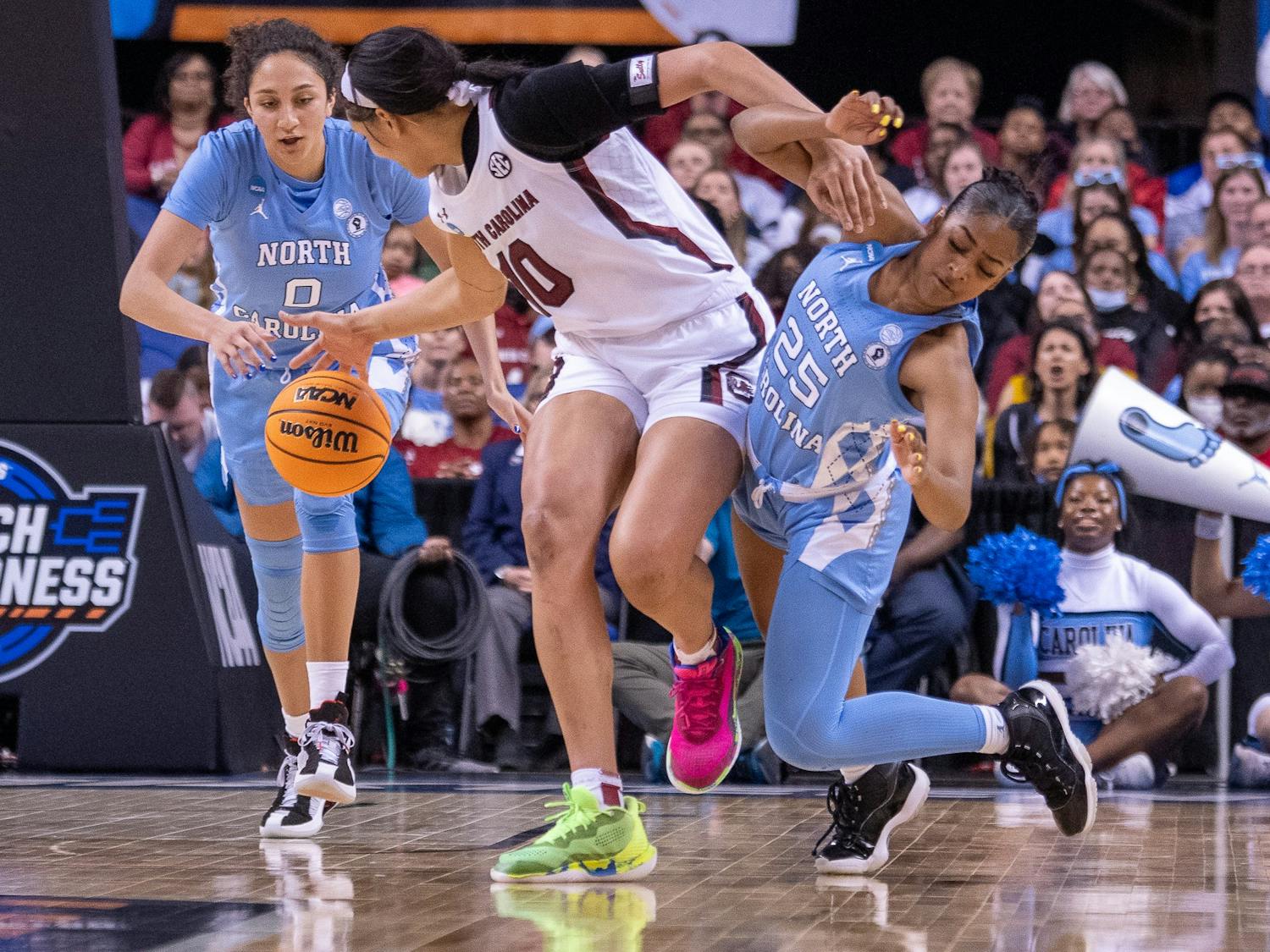 Sophomore guard Deja Kelly (25) and sophomore forward Alexandra Zelaya (0) go for the ball at the NCAA Sweet 16 game against South Carolina in Greensboro. UNC lost 61-69.