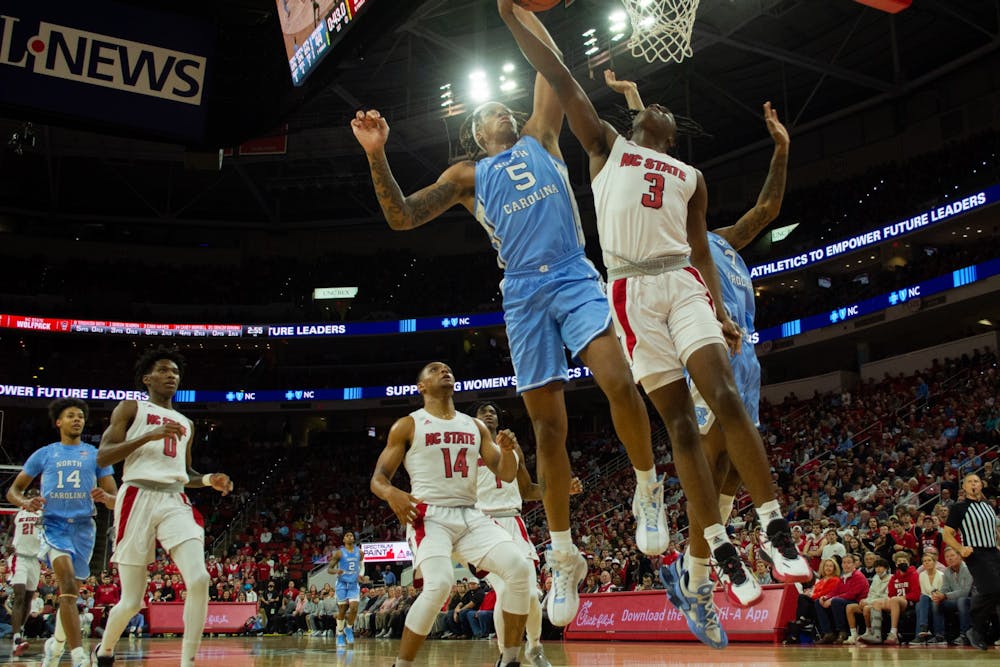 Junior forward Armando Bacot (5) goes for the goal during UNC"S rivalry matchup against NC State on Feb. 26, 2022 in PNC Arena in Raleigh, NC. UNC won with a 84-74 final score, and Bacot left with 18 rebounds, matching Billy Cunningham's 1965 record for UNC rebounds against NC State.