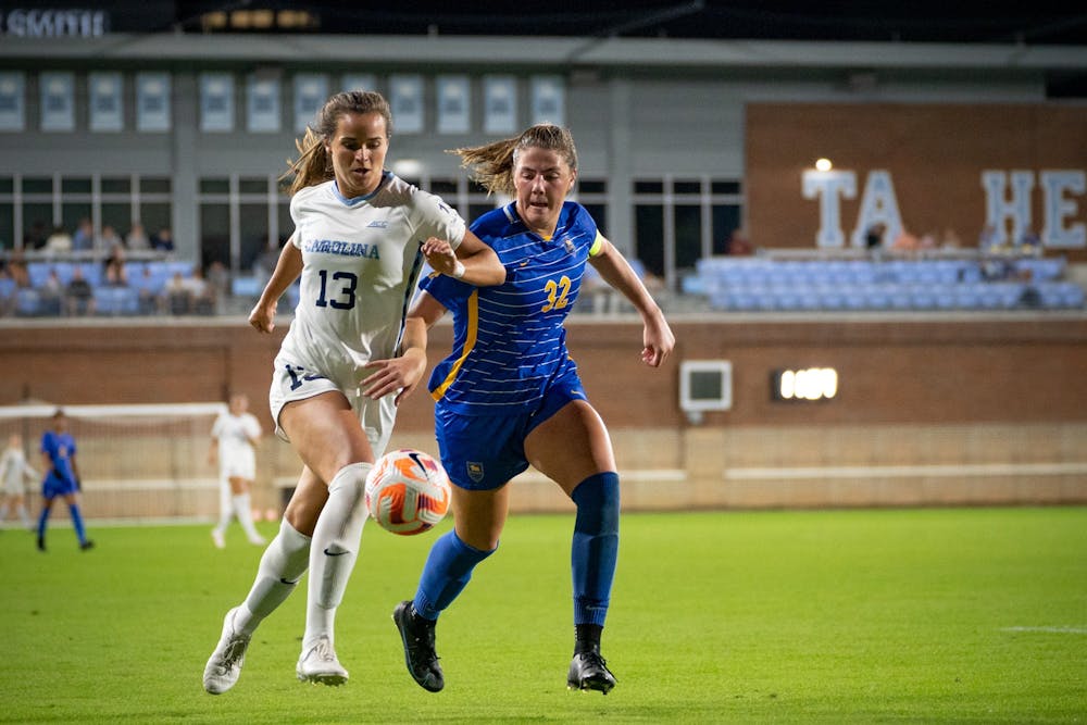 UNC senior forward Isabel Cox (13) fights for the ball during the women's soccer game against Pittsburgh on Oct. 6, 2022 at Dorrance Field. UNC beat Pittsburgh 4-0.