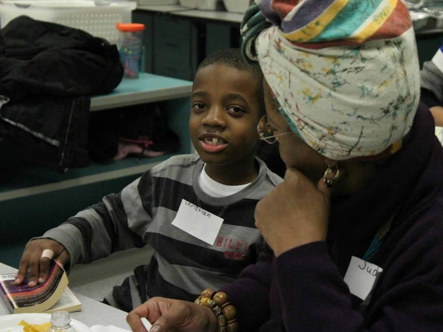 Christian and his mom talk get ready to read during McDougle Elementary School's first Family Reading Partners program event.