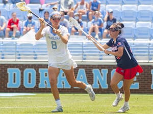UNC redshirt-senior attacker Katie Hoeg (8) runs with the ball at the quarterfinals of the NCAA tournament against Stony Brook at the Dorrance Field in Chapel Hill on Saturday May 22, 2021. The Tar Heels won 14-11.
