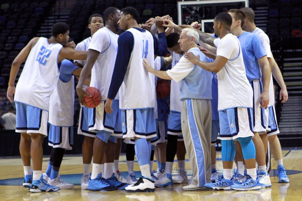 The team huddles at center court to end the practice. The UNC men's basketball team held an open practice at the AT&T Center in San Antonio on Thursday. The Tar Heels will face Providence in the second round of the NCAA tournament on Friday.