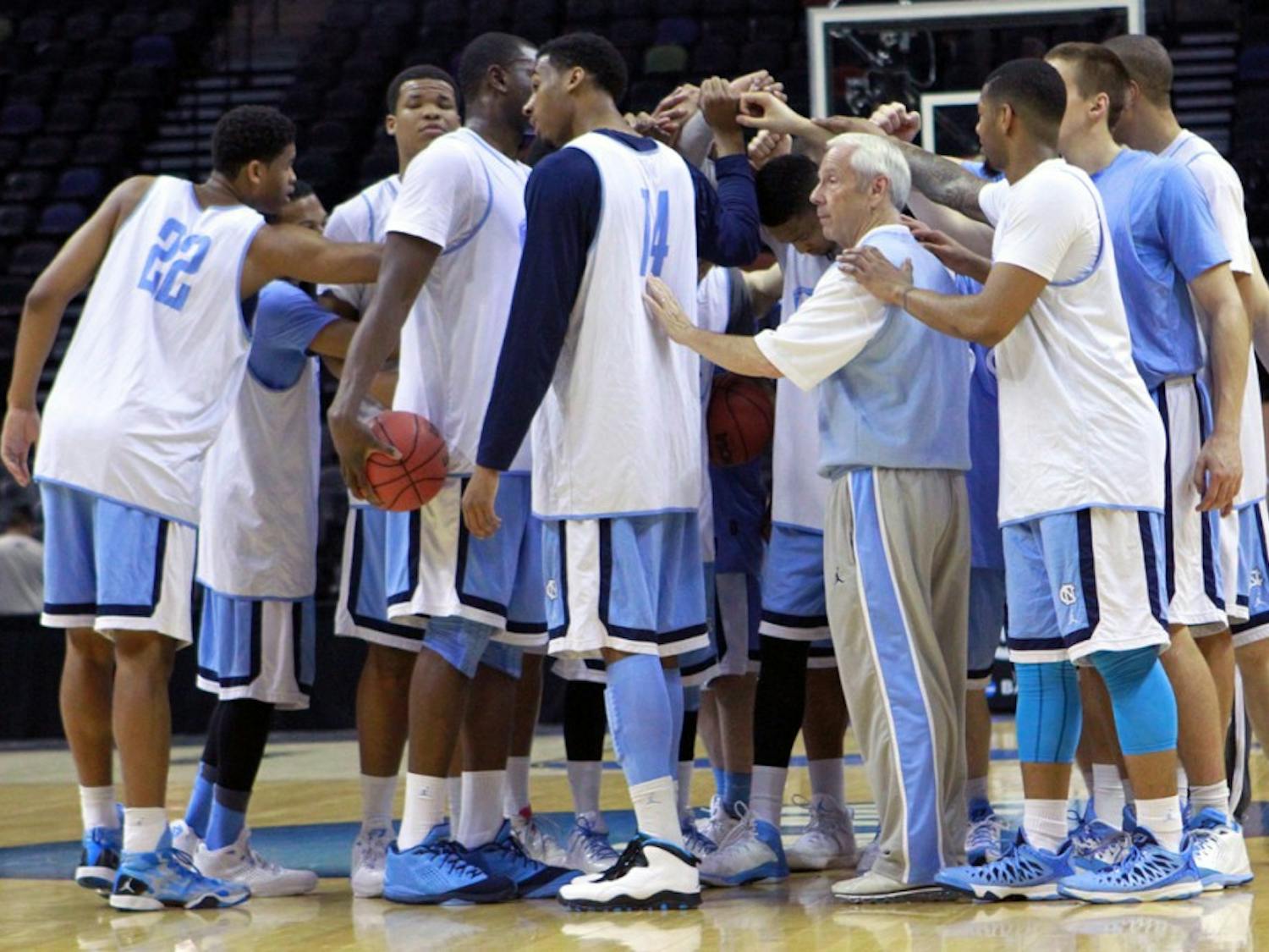 The team huddles at center court to end the practice. The UNC men's basketball team held an open practice at the AT&T Center in San Antonio on Thursday. The Tar Heels will face Providence in the second round of the NCAA tournament on Friday.