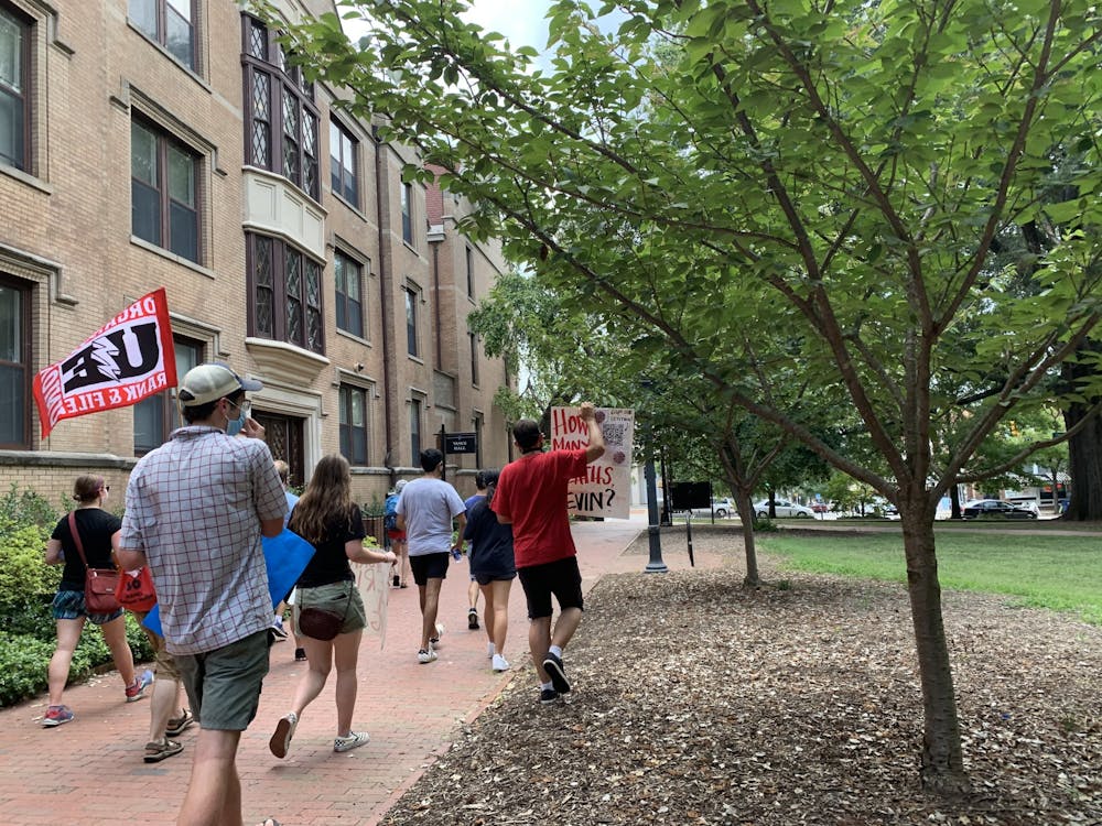 <p>UNC System workers march across campus towards South Building on Friday, July 17, 2020 to protest the university’s approach to reopening.</p>