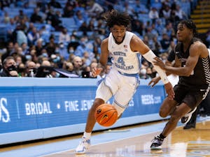 Sophomore guard RJ Davis (4) evades a defender during a game against Brown at the Smith Center on Nov. 12. The Tar Heels defeated Brown 94-87, earning their second win of the season.