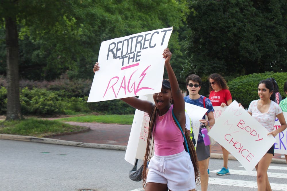 UNC student demonstrators march from the Old Well to the the Pit on July 24, 2022.