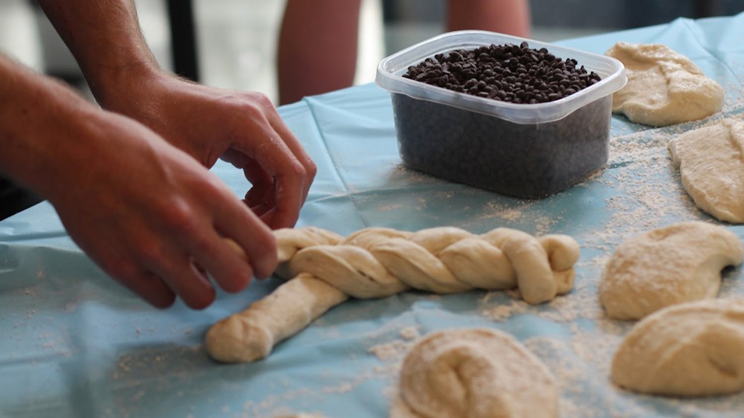 Students weave dough for the Challah for Hunger bake sale. Challah is a traditional Jewish bread eaten on Sabbath and holidays. 