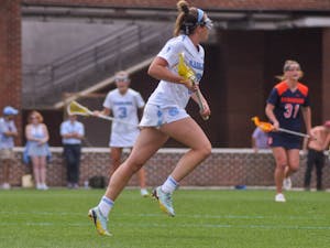 UNC senior midfielder Nicole Humphrey (9) storms down the field with the ball during the women's lacrosse game against Syracuse at Dorrance Field on Saturday, April 15, 2023.