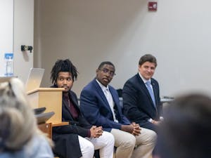 Student Body President candidates TJ Edwards, Chris Everett and Sam Robinson listen to the moderator of UNC-CH's Young Democrat's SBP Town Hall in Chapel Hill, N.C., Feb. 7, 2023.
