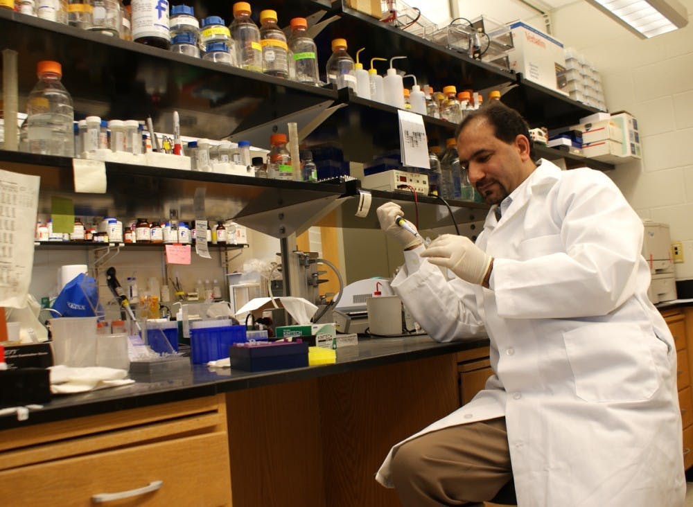 Manzoor Bhat works in his lab in the Neuroscience Center in 2011.