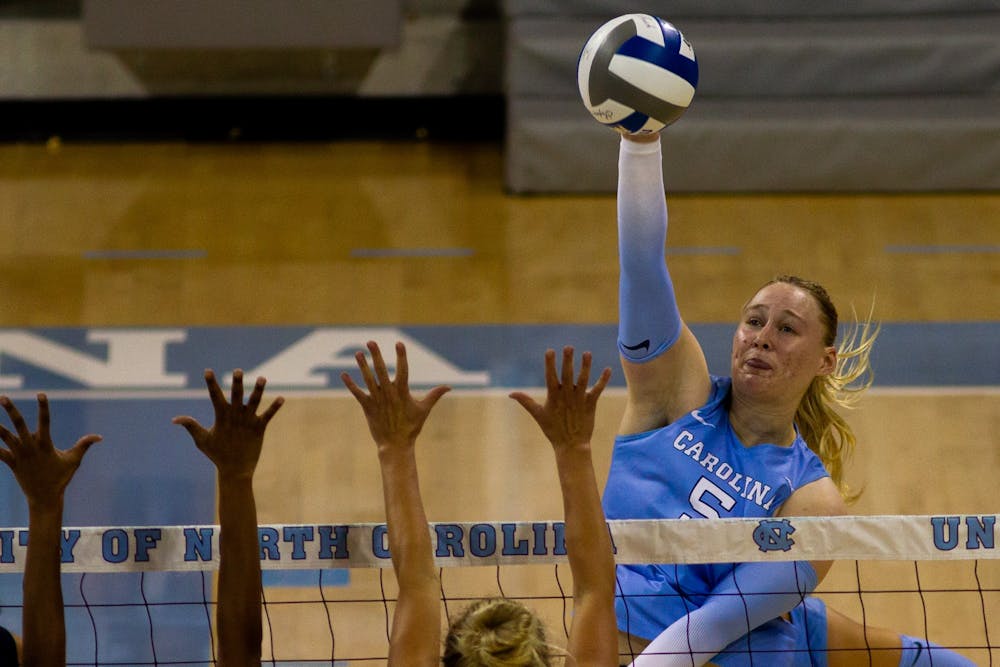 UNC outside hitter Charley Niego (5) spikes the ball over the net. UNC beat High Point 3-2 at home on Saturday, Aug. 20, 2022. 