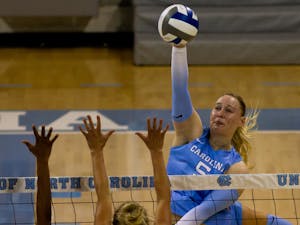 UNC outside hitter Charley Niego (5) spikes the ball over the net. UNC beat High Point 3-2 at home on Saturday, Aug. 20, 2022. 
