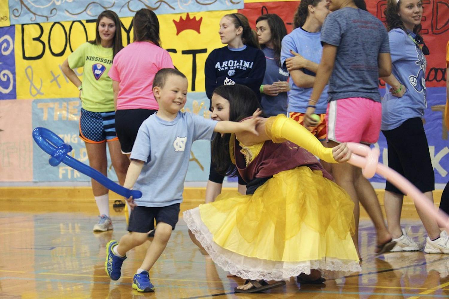 UNC's annual 24-hour standing and dancing Dance Marathon took place on March 21 and 22. The organization ended up raising 551, 595.87 dollars for the patients and families at UNC's Childrens Hospital, passing the half a million mark for the first time in history. Pictured: Jake Ellis plays with moral and kid co-captain Katie Quine. 