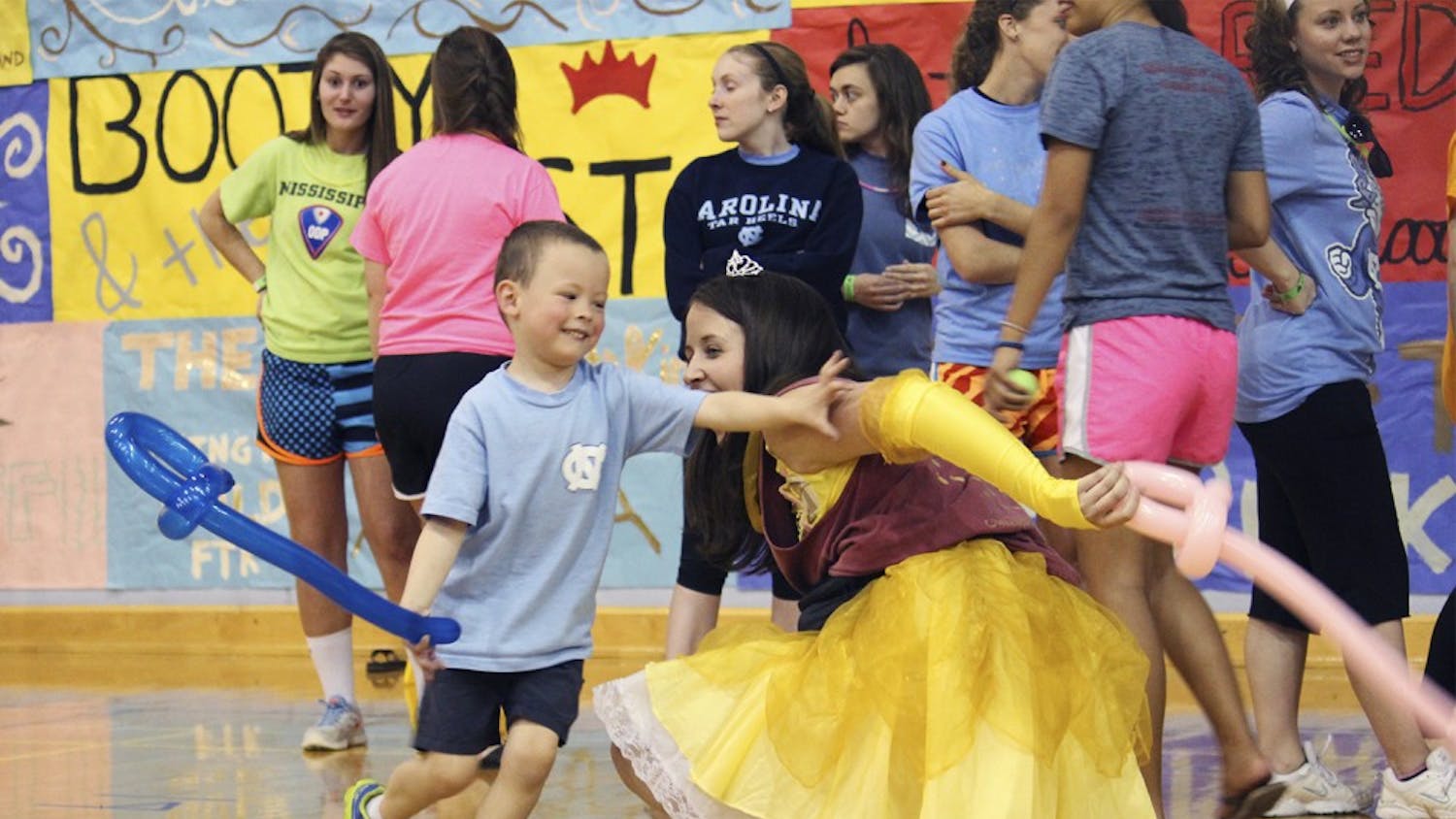 UNC's annual 24-hour standing and dancing Dance Marathon took place on March 21 and 22. The organization ended up raising 551, 595.87 dollars for the patients and families at UNC's Childrens Hospital, passing the half a million mark for the first time in history. Pictured: Jake Ellis plays with moral and kid co-captain Katie Quine. 