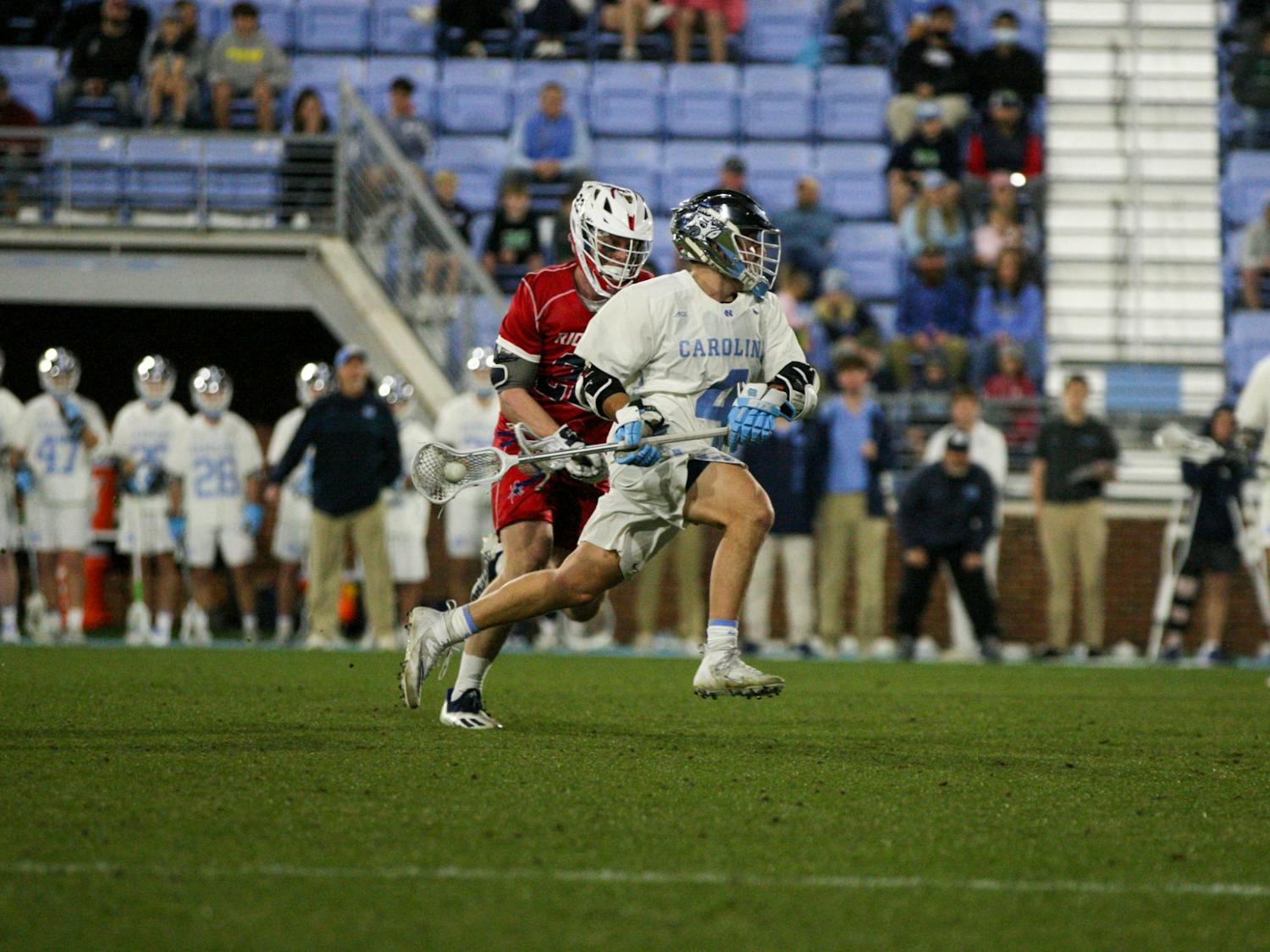 Graduate attackman Chris Gray (4) sprints past his defender to the goal on February 11, 2022 at Dorrance Field. UNC won their season opener against Richmond 13-9. 