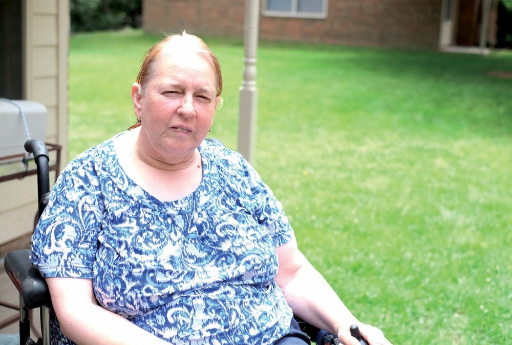 Ellen Perry sits outside of her home in  Carrboro Friday afternoon. Perry helped create the 2015 Chapel Hill Access Guide for the Orange County Visitors Bureau.