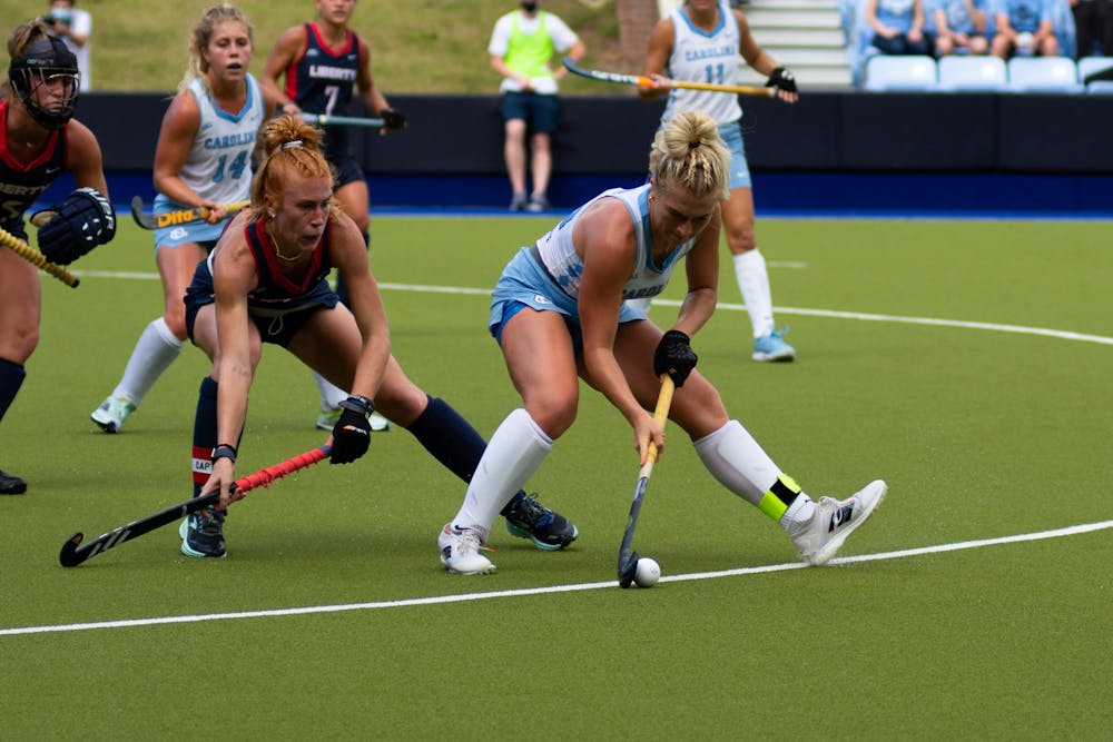 Senior midfielder Cassie Sumfest (12) defends the ball during UNC's Oct. 10 field hockey game against Liberty. The game proved to be a loss for the Tar Heels–Liberty headed home with a 4-0 win.