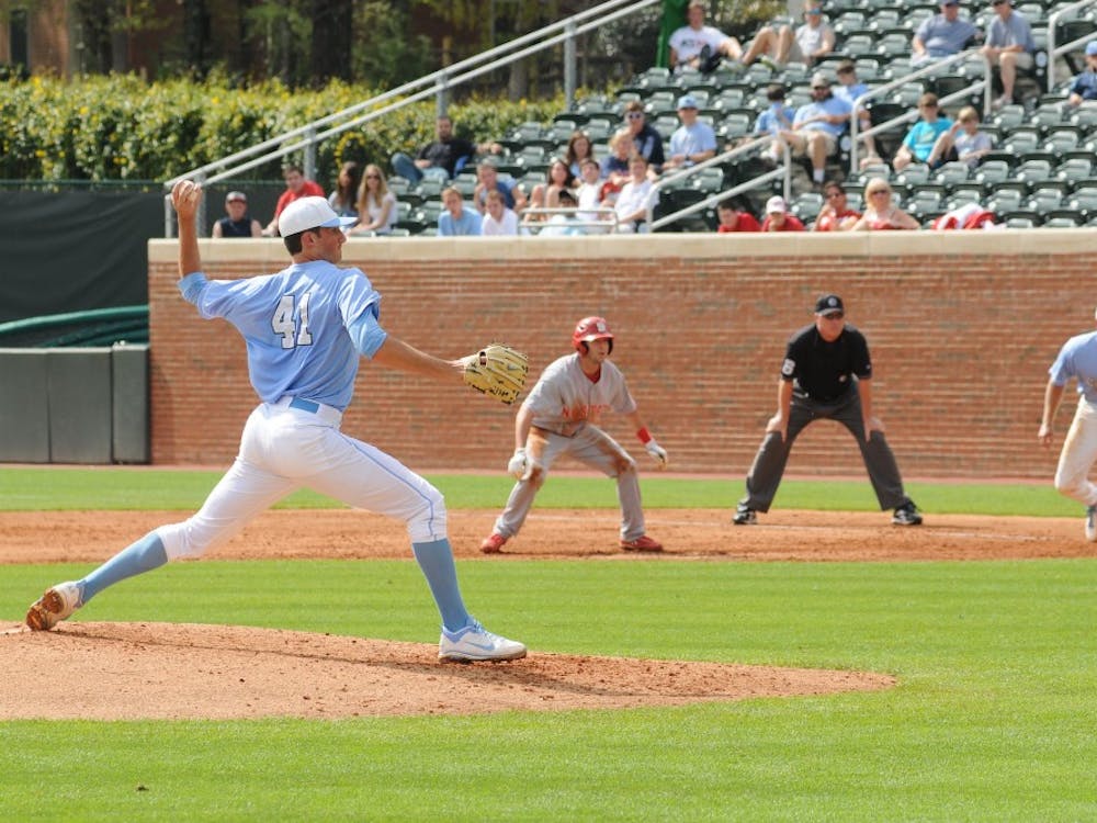 Left handed pitcher Kent Emanuel (41) throws a pitch as Cody Stubbs (25) hold on a NC State runner in Carolina's 3-1 loss to NC State at Boshamer Stadium in Chapel Hill Saturday, March 24th. 