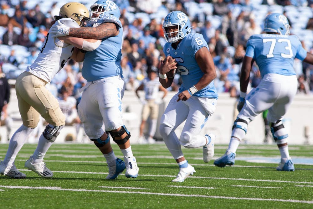 UNC sophomore quarterback Jacolby Criswell (6) rushes past Wofford's defense on Nov. 20 at Kenan Stadium. UNC beat Wofford 34-14.