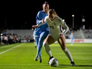 UNC junior forward Talia DellaPeruta (24) fights for the ball during UNC's game against FSU in the NCAA semifinals at WakeMed Soccer Park on Friday, Dec. 2, 2022.