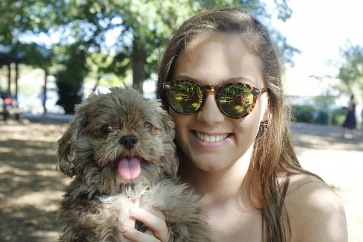 UNC sophomore Laura Perron enjoys a Sunday afternoon with her dog, Hershey, at Weaver Street Market, a dog friendly establishment in Carrboro.