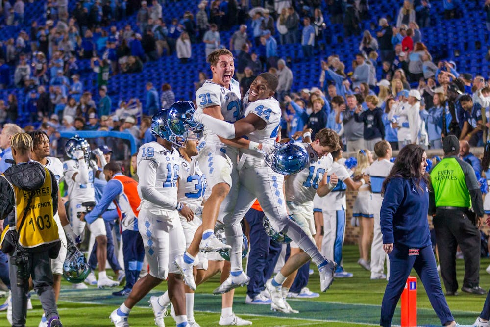 The UNC football team celebrates their win after the game against Duke on Saturday, Oct. 15, 2022, at the Wallace Wade Stadium. UNC beat Duke 38-35.