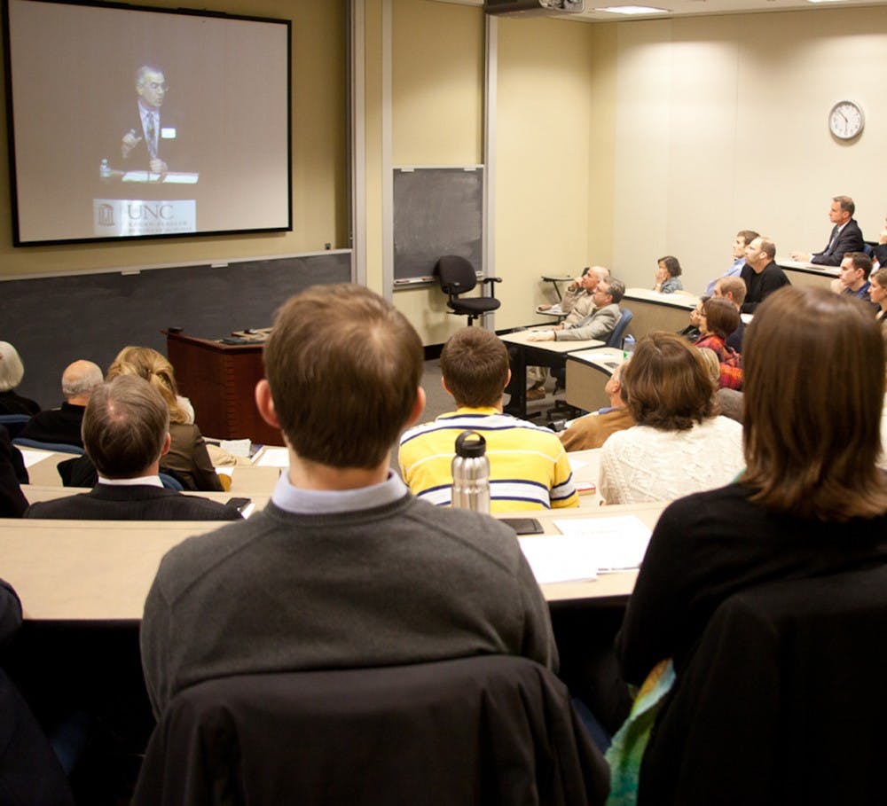 Audience members watch a live stream of David Brook's speech while in a classroom in the Kenan Business Center on Jan 24. Three classrooms were used to hold overflow audience after the 388-seat Koury Auditorium reached maximum capacity in advance of the free lecture.