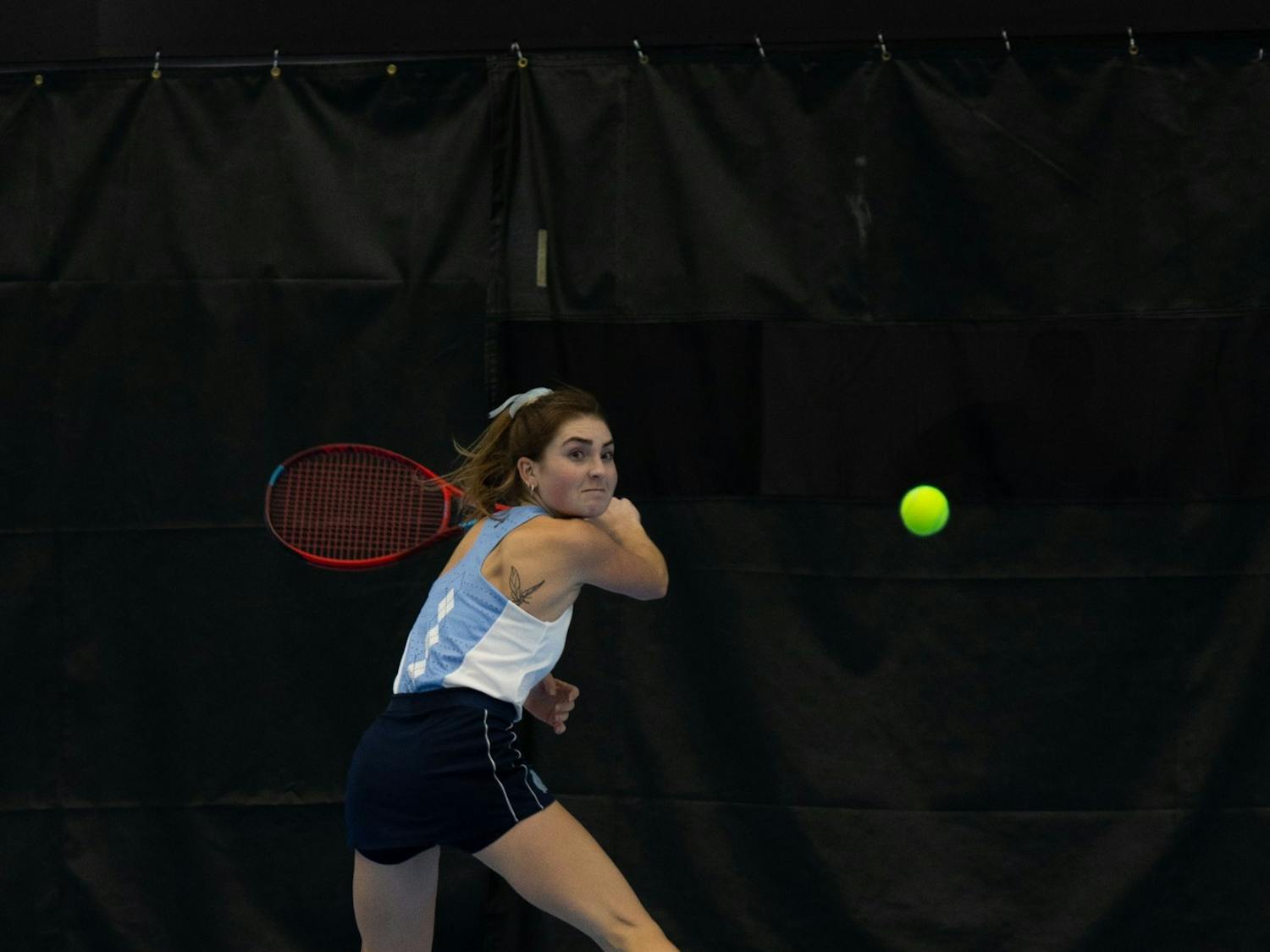 Junior Fiona Crawley returns a volley during her singles match against Elon University’s Sibel Tanik at the Cone-Kenfield Tennis Center on Friday, January 13, 2023. UNC beat Elon 4-2.