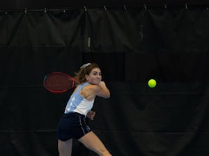 Junior Fiona Crawley returns a volley during her singles match against Elon University’s Sibel Tanik at the Cone-Kenfield Tennis Center on Friday, January 13, 2023. UNC beat Elon 4-2.
