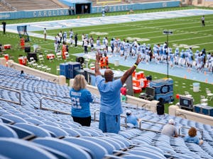 Parents of UNC graduate student and linebacker Chazz Surratt Brandi and Kevin Surratt cheer from the stands of Kenan Memorial Stadium during a game against Syracuse on Saturday, Sept. 12, 2020. UNC beat Syracuse 31-6.&nbsp;