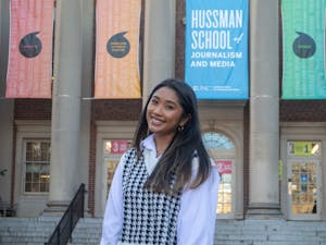 Tran Nguyen, a junior media and journalism major, poses in front of Carroll Hall, home of the Hussman School of Media and Journalism, on Thursday March 4, 2021.
