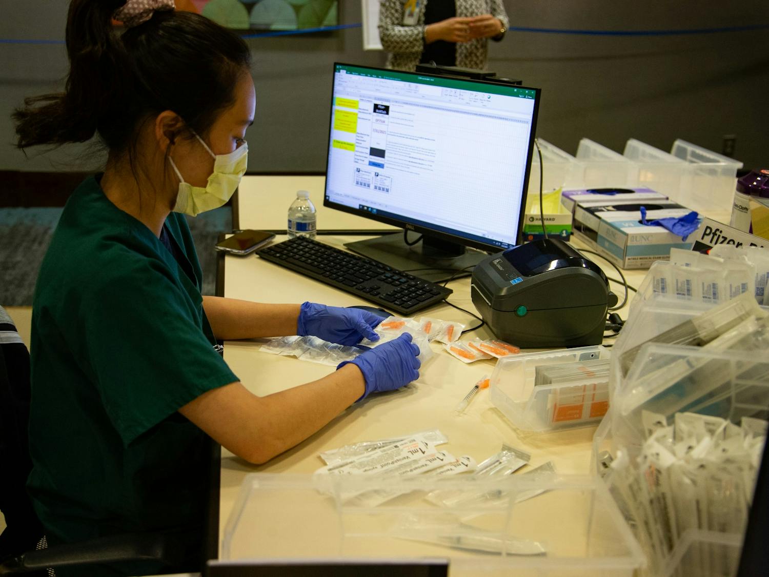 Fourth year pharmacy student Hannah Kim prepares syringes at the end of a day of of vaccinations at the Friday Center on Monday, Mar. 22, 2021.