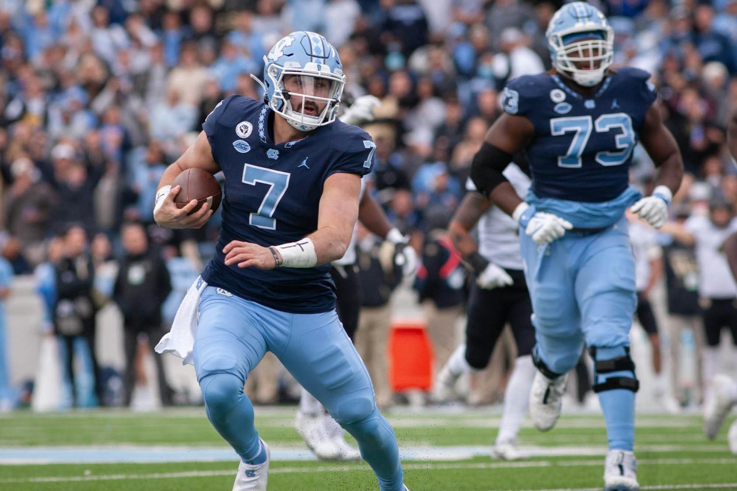 Junior quarterback Sam Howell runs with the ball during the UNC 