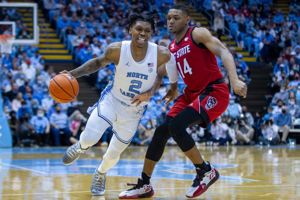 Sophomore guard Caleb Love (2) runs with the ball at the game against NC State at the Smith Center in Chapel Hill on Jan. 29, 2022. UNC won 100-80.