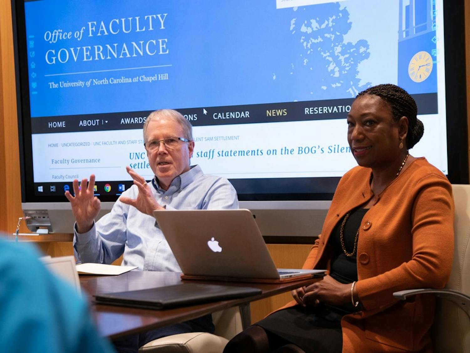 Jim Leloudis (middle) and Patricia Parker (right), co-chairs of UNC's new Reckoning Commission, discuss the Commission on History, Race and a Way Forward with Jennifer Larson (left) during the Faculty Executive Meeting at South Building on Monday, Jan. 13, 2020.&nbsp;
