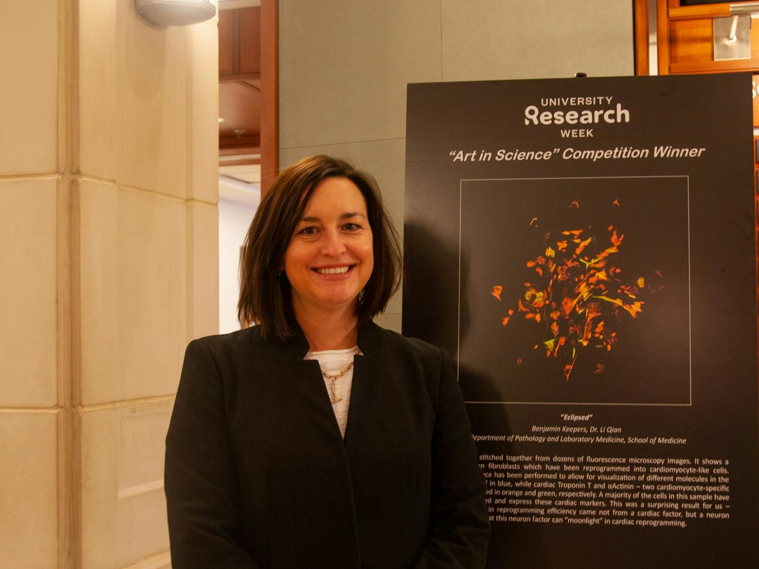 Layla Dowdy poses in front of the “Art in Science” exhibit at Bondurant Hall on Nov. 8. Dowdy is the Director of the office of Research Communications and is a main organizer of the University Research Week.  