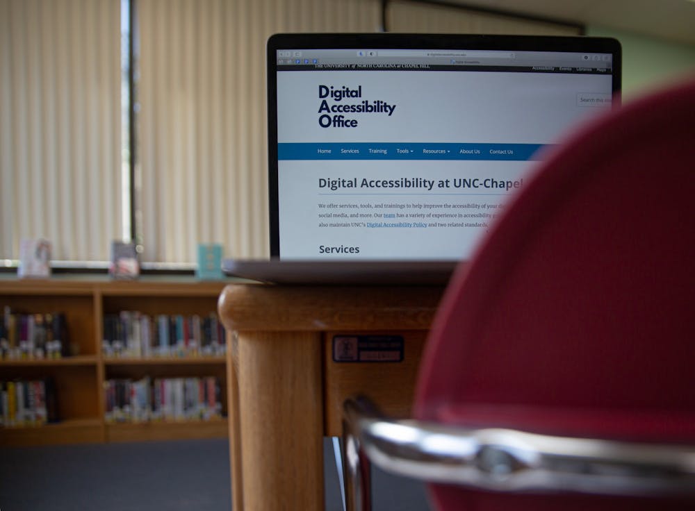 DTH Photo Illustration. A computer screen shows the homepage for UNC's Digital Accessibility Office. The DAO offers training, consulting and resources to ensure that digital materials are available to students.